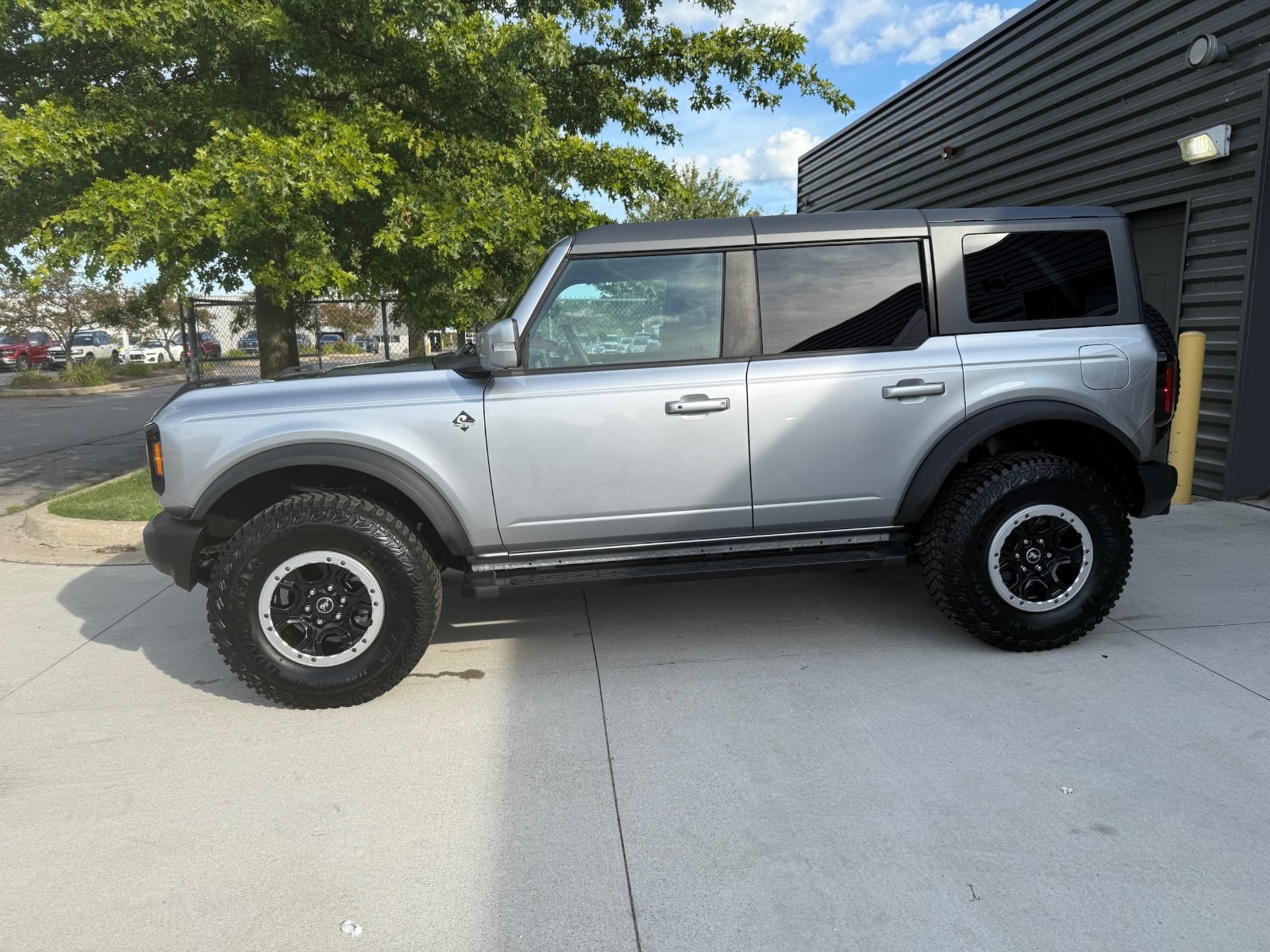 2024 Ford Bronco Outer Banks in Iconic Silver parked outside the Friendly Ford service building